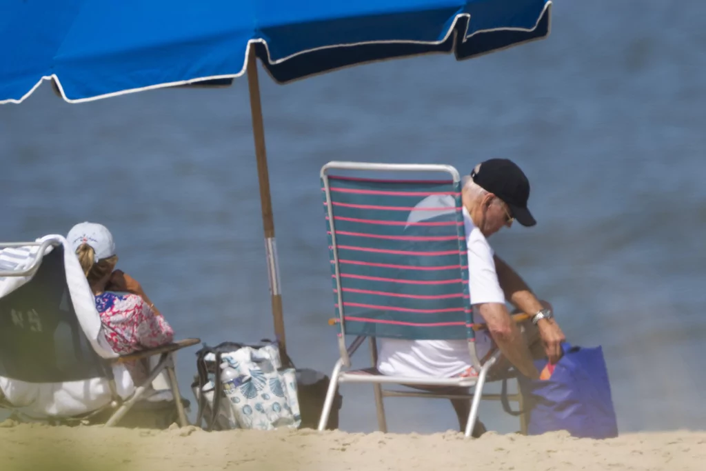 Biden spotted lounging on the beach for a second straight week of vacation: ‘This is absurd’