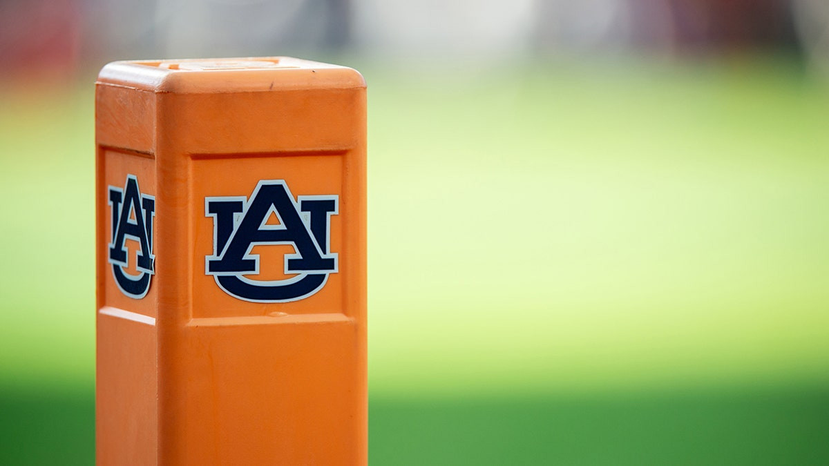 Auburn cheerleader knocks down Oklahoma player running onto field while performing stunts  at george magazine