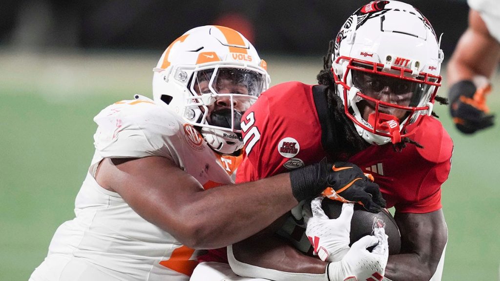 Tennessee player shoves fan storming field to the ground after upset loss to Arkansas