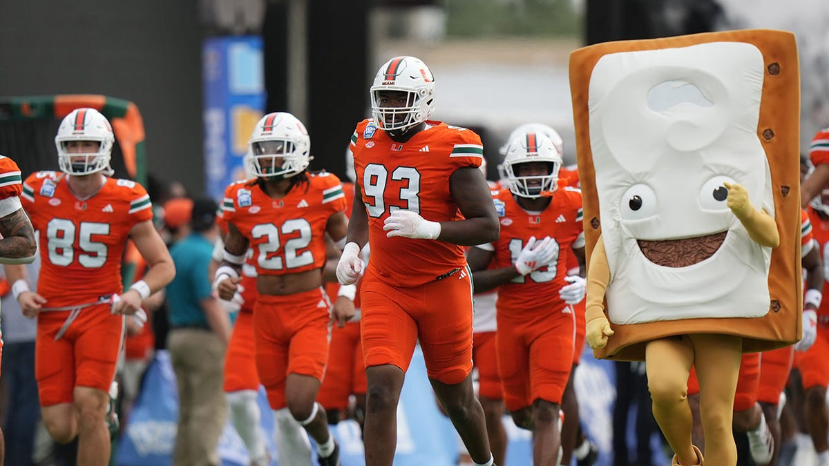 Miami teammates fight on sideline during Pop-Tarts Bowl  at george magazine