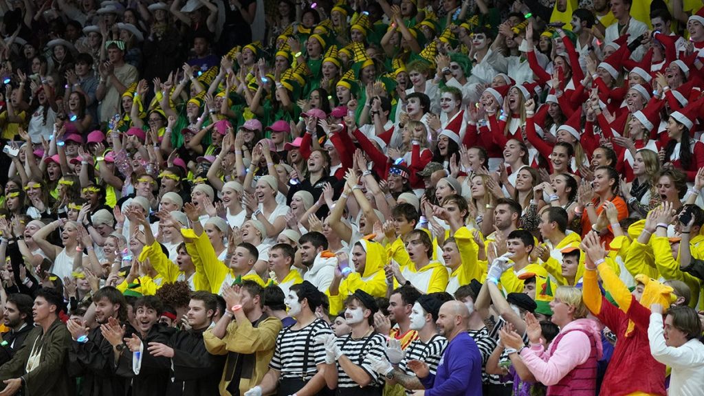 College basketball fans break silence, storm the court as part of unique Christmas tradition