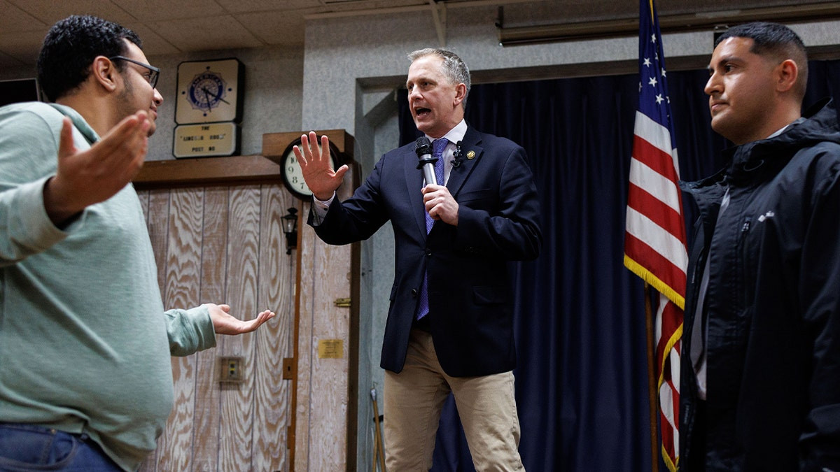 'Soulless piece of crap': Angry protester jumps on stage during Dem rep's town hall  at george magazine