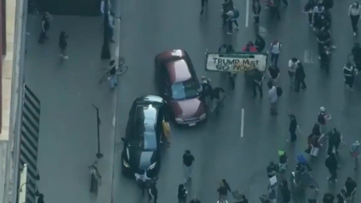 Car drives through anti-ICE protesters as Chicago joins nationwide anti-ICE unrest amid Trump crackdown  at george magazine