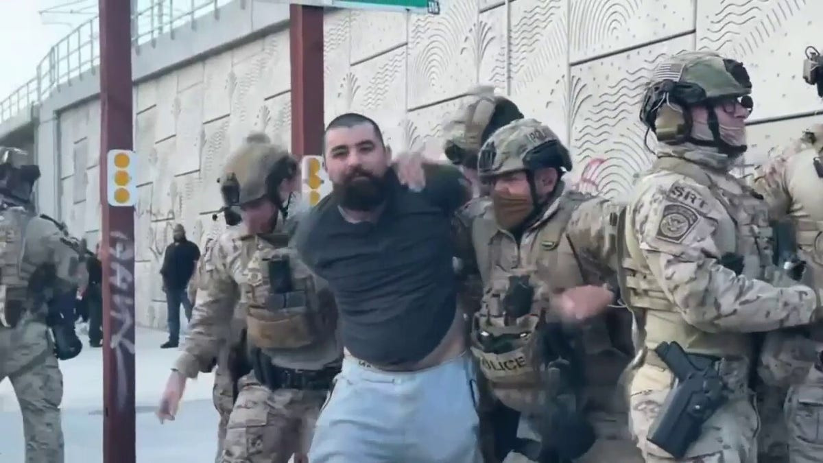 Los Angeles protester charged with throwing rock at federal officer's face shield  at george magazine