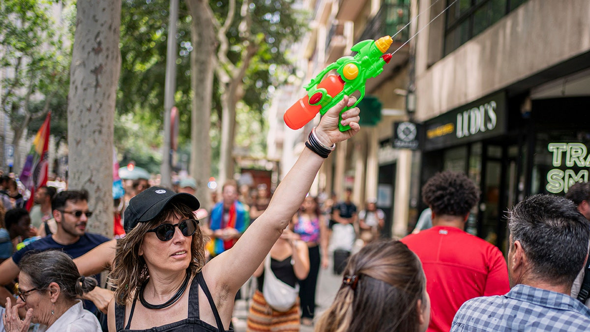 Tourists sprayed with water guns by protesters as European anti-tourism trend grows  at george magazine