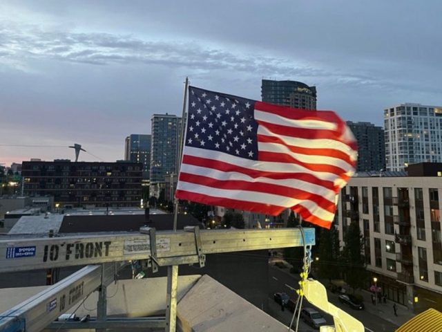 Patriotic ICE officer replaces American flag after protesters burned existing banner at Portland facility