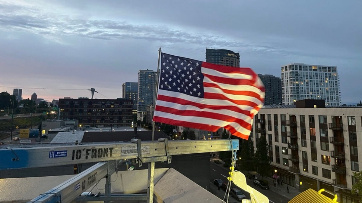 Patriotic ICE officer replaces American flag after protesters burned existing banner at Portland facility  at george magazine