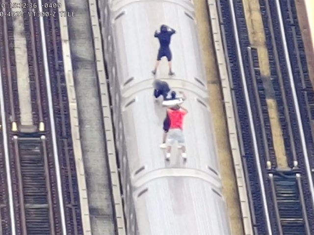 Drone surveillance catches kids in dangerous high-speed stunt atop moving subway train in New York City