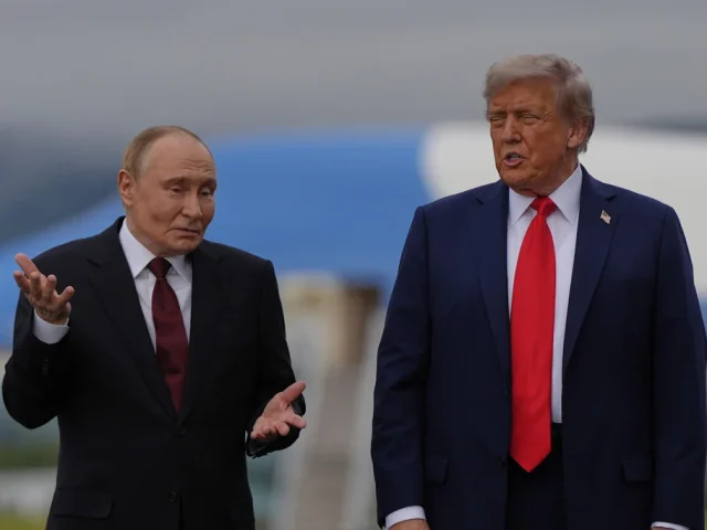 Putin taps ear and shrugs when asked whether he would stop ‘killing civilians’