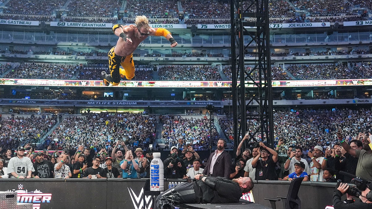 Logan Paul provides highlight reel moment with frog splash onto Jelly Roll through table at SummerSlam  at george magazine