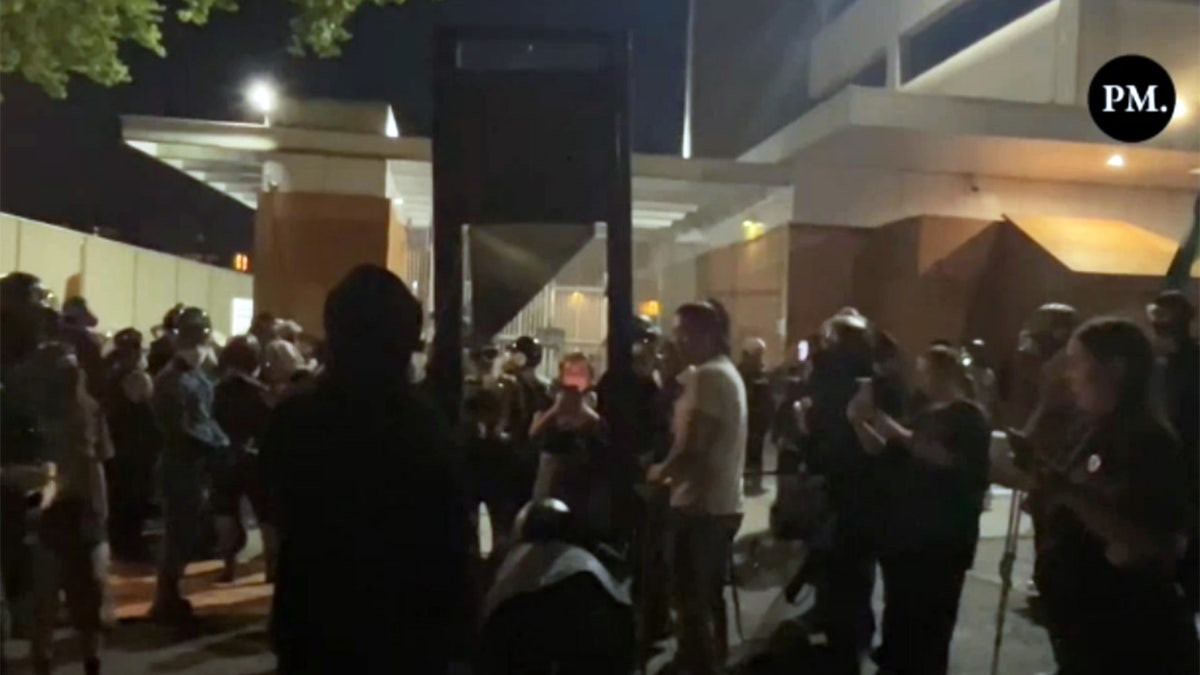 Anti-ICE Portland rioters with guillotine clash with police, burn flag in war-like scenes  at george magazine
