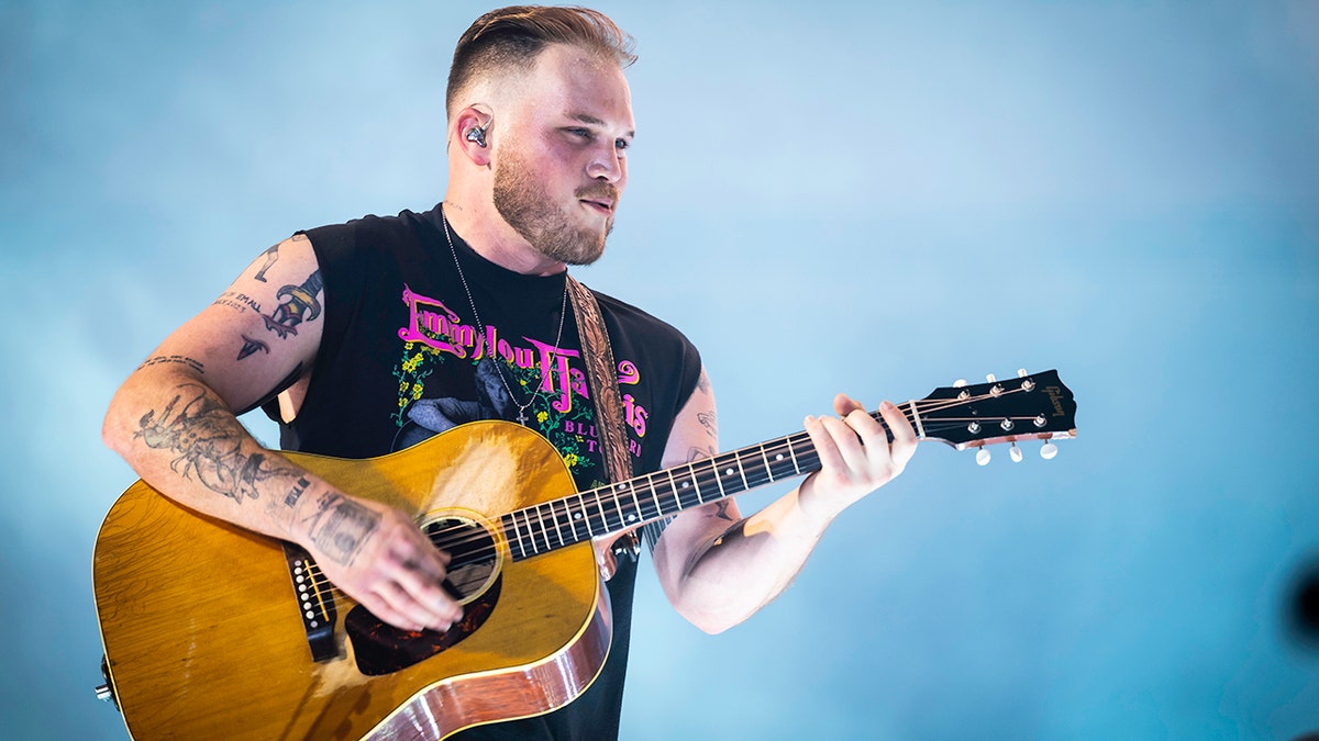 Country singer Zach Bryan releases statement on controversial song, insisting 'I love this country'  at george magazine