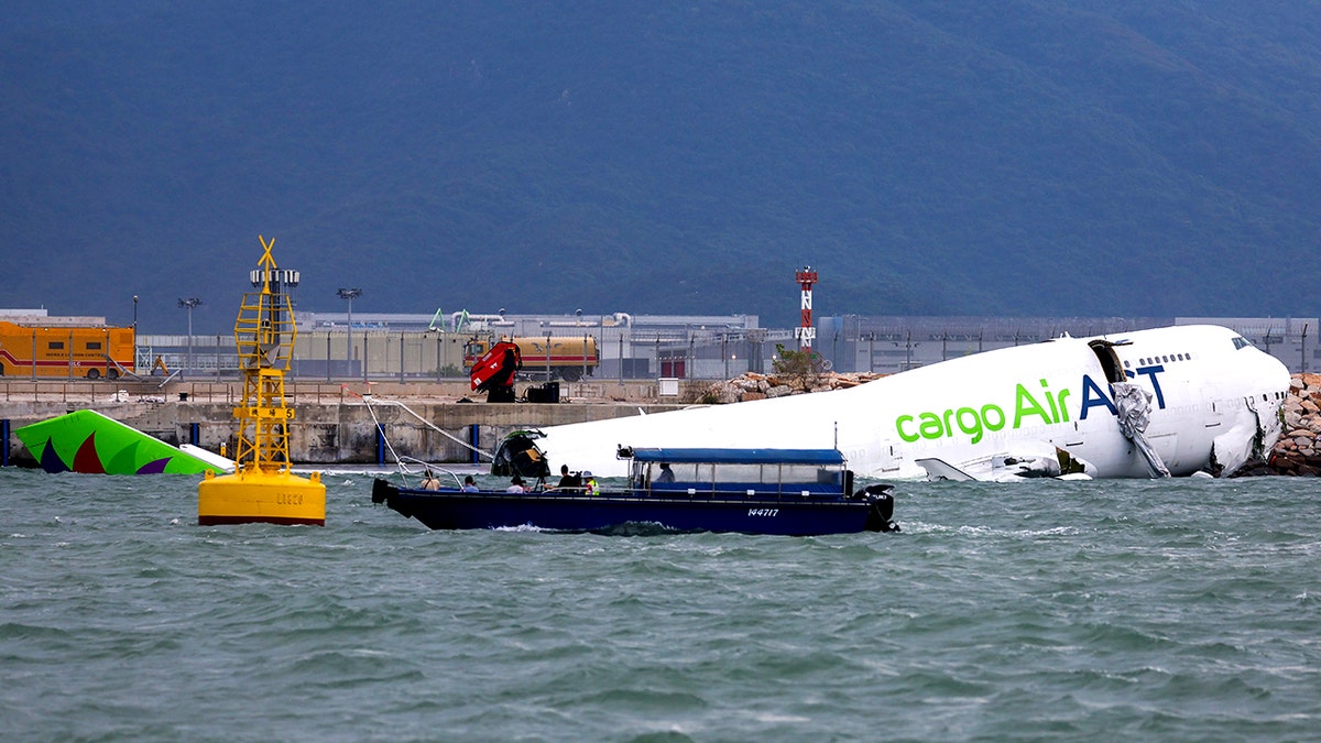 Hong Kong cargo plane skids off runway, killing two  at george magazine