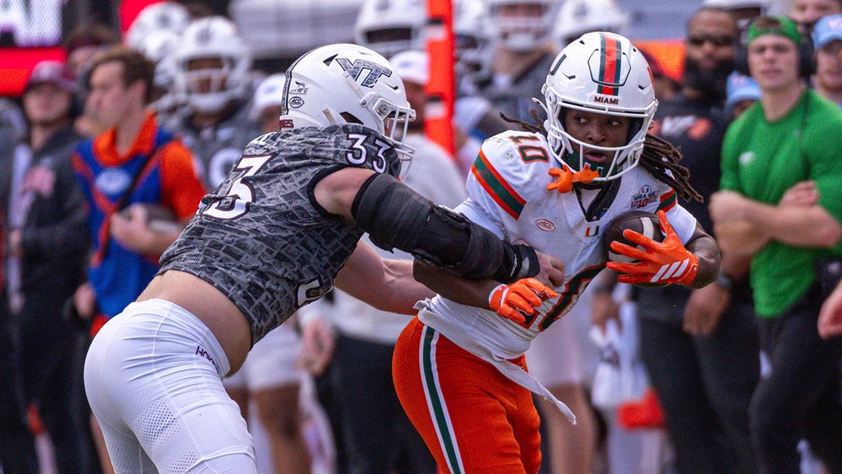 Miami football staffer avoids disaster after Hurricanes player barrels over her at george magazine