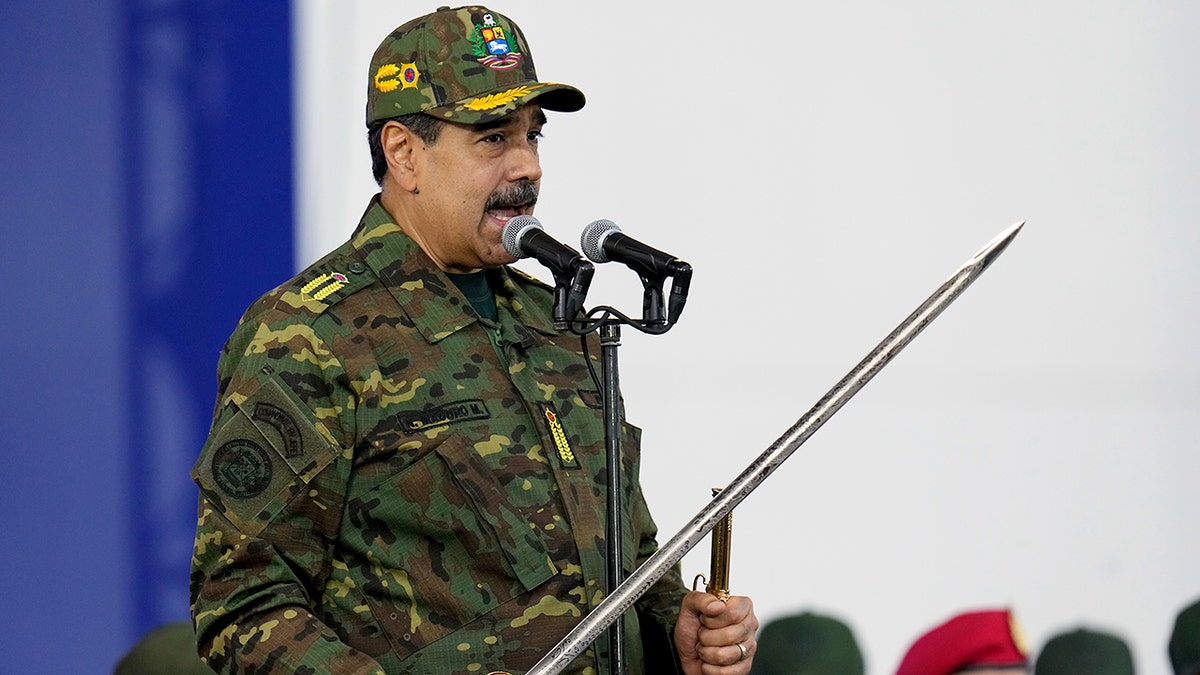 Maduro brandishes sword at rally as he rails against 'imperialist aggression' amid rising tensions with US at george magazine