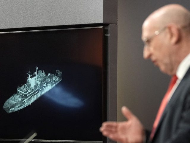 Britain says Russian spy ship is on edge of UK waters, as defense secretary issues warning to Putin