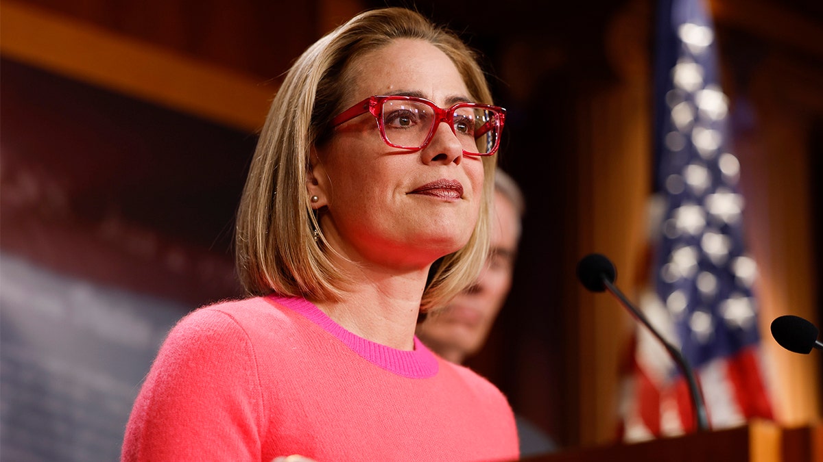 Biden DOJ and FBI considered criminal probe into Kyrsten Sinema after she left Democratic Party at george magazine