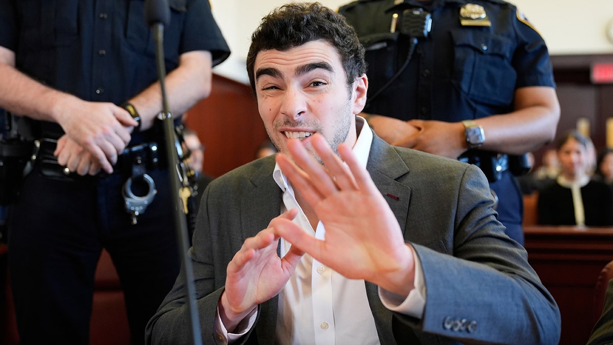 Luigi Mangione smiles for cameras in court as defense claims police violated his rights at george magazine