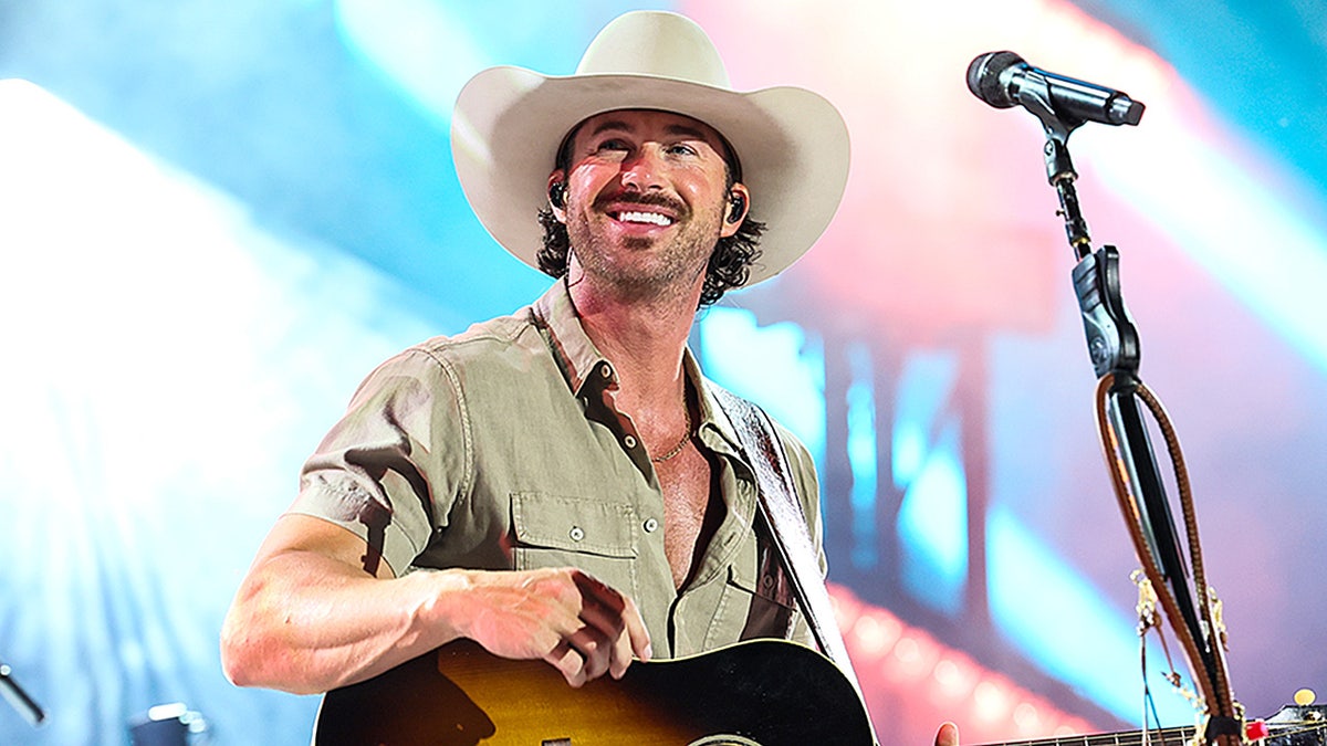 Country star Riley Green admits fame is 'not reality' compared to farm life in Alabama at george magazine