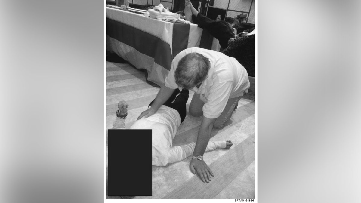 Ex-Prince Andrew photographed kneeling over woman in latest DOJ Jeffrey Epstein file release at george magazine