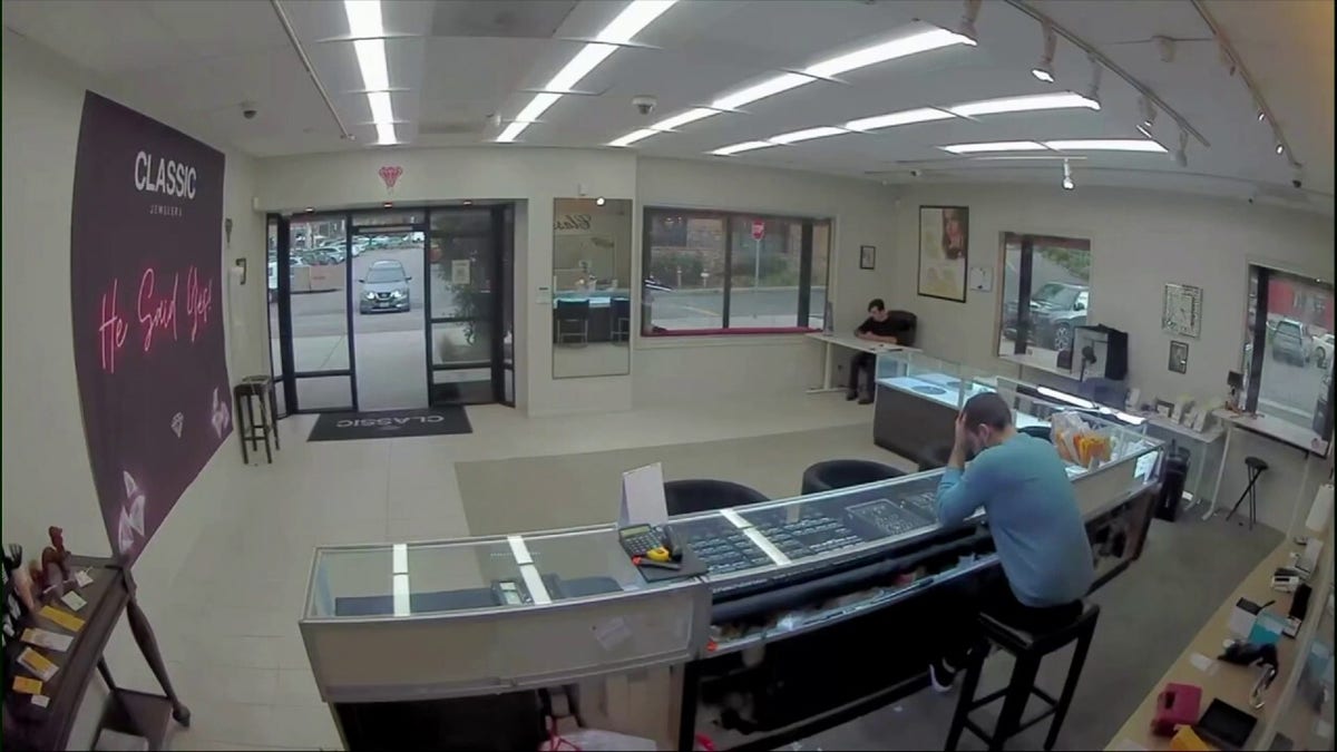 Video shows masked robbers crash car through jewelry store entrance, steal owner's gun in brazen heist at george magazine