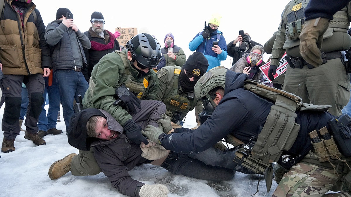 Minneapolis protesters confront federal agents day after deadly shooting at george magazine