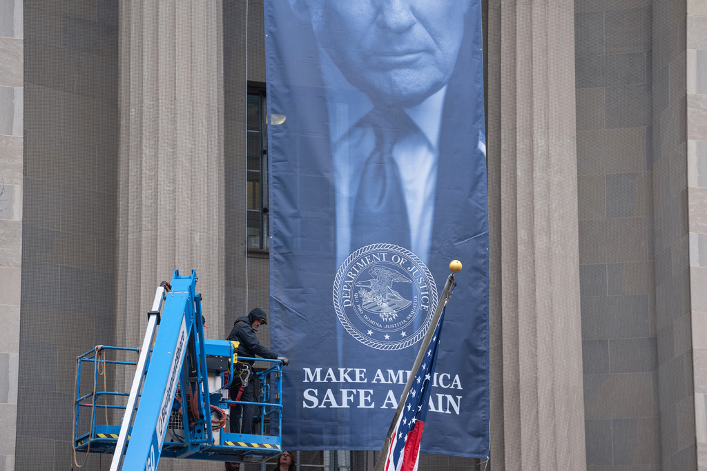 Giant Trump banner hung on Justice Department headquarters at george magazine