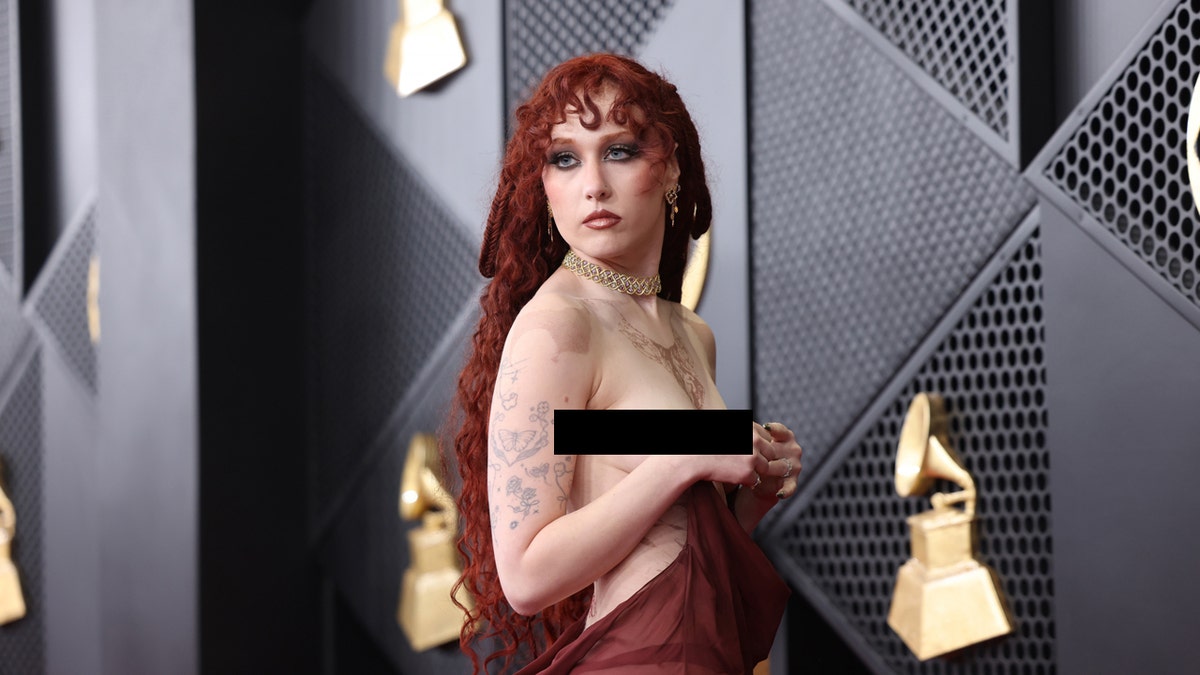 Chappell Roan says she's 'giggling' over Grammys outfit controversy after debuting nipple-piercing dress at george magazine