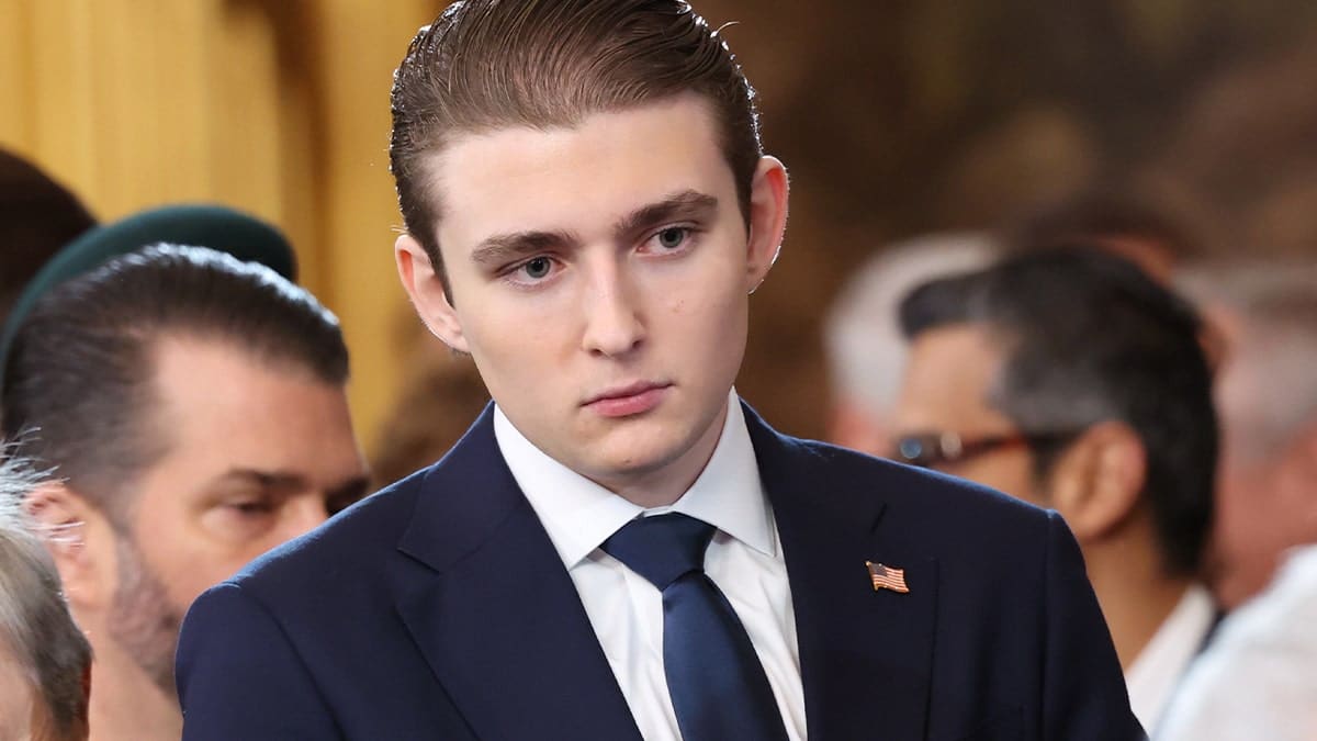 barron trump in suit looking onward