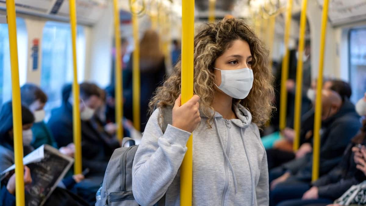 Girl wearing mask on train
