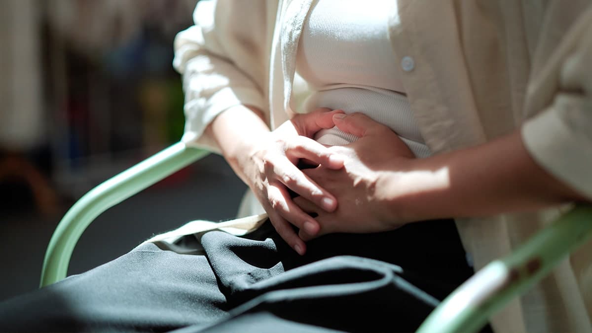 Woman clutching stomach