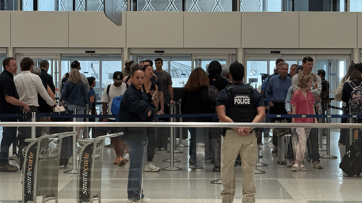 ICE agents looking on as travelers pass through at airport