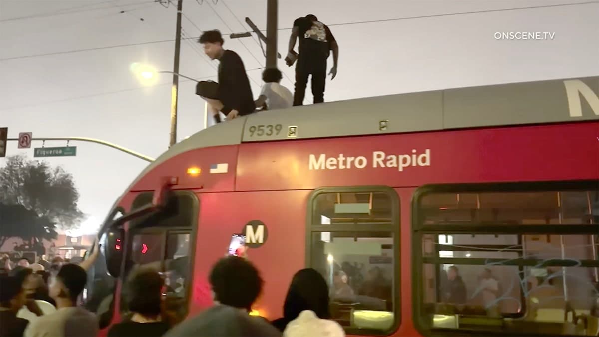 People stand on LA metro bus