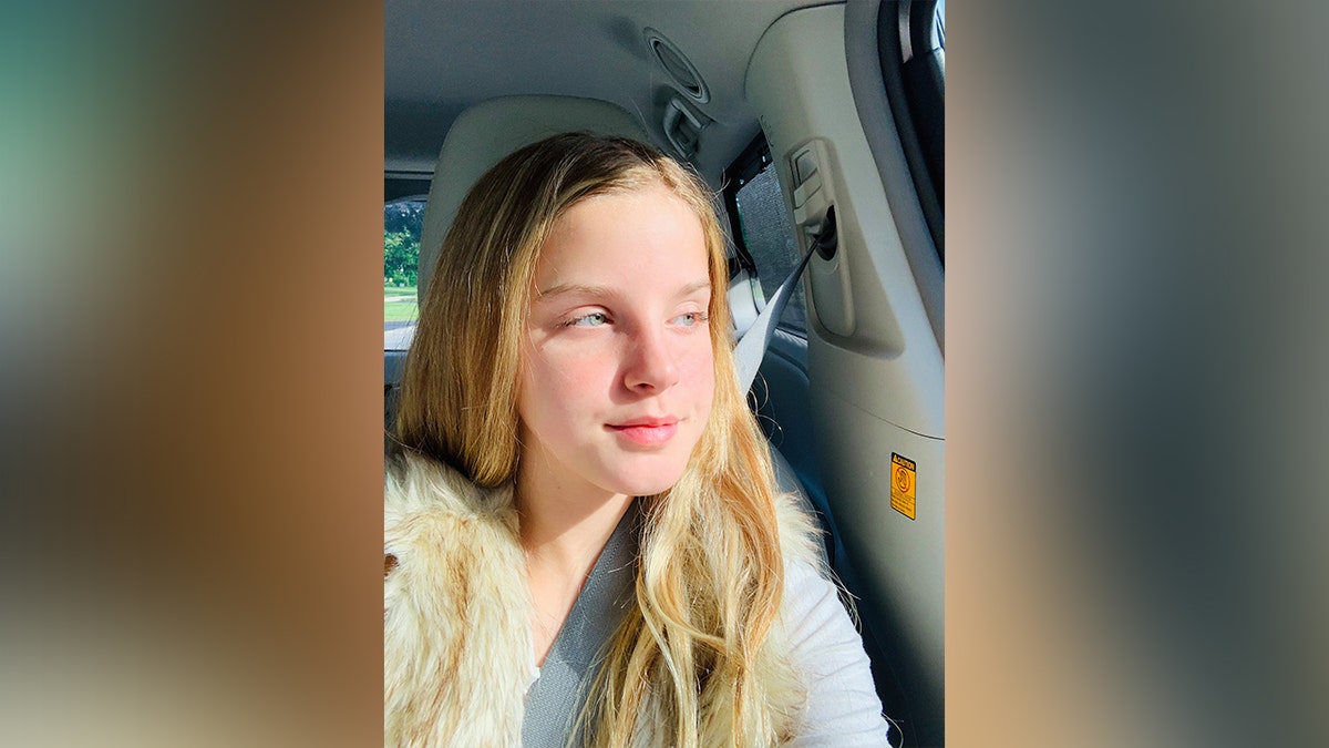 Lilly bova looks out car window