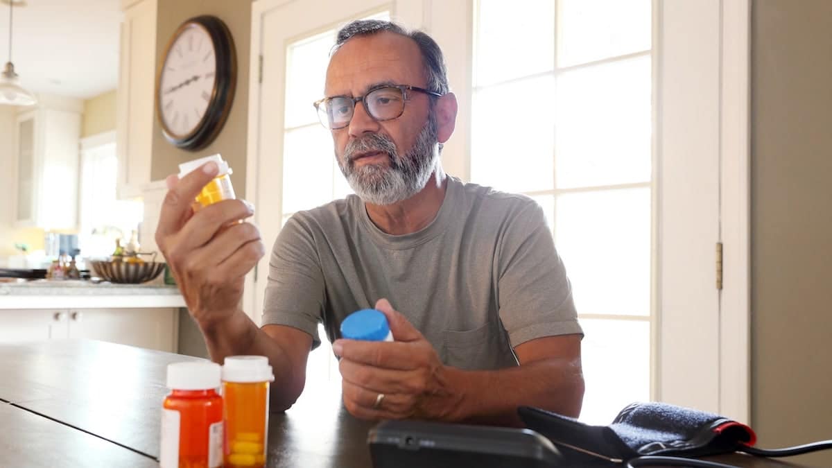 Man holding blood pressure medications