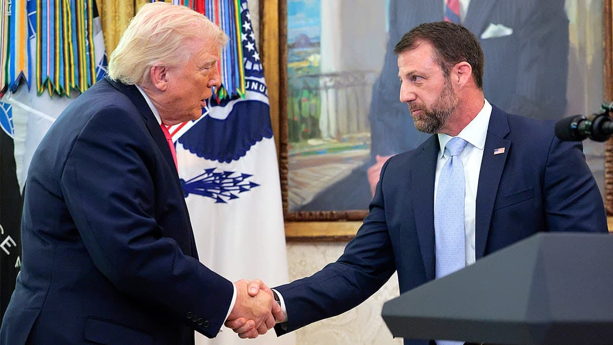 President Donald Trump shakes hands with DHS Secretary Markwayne Mullin in the Oval Office.