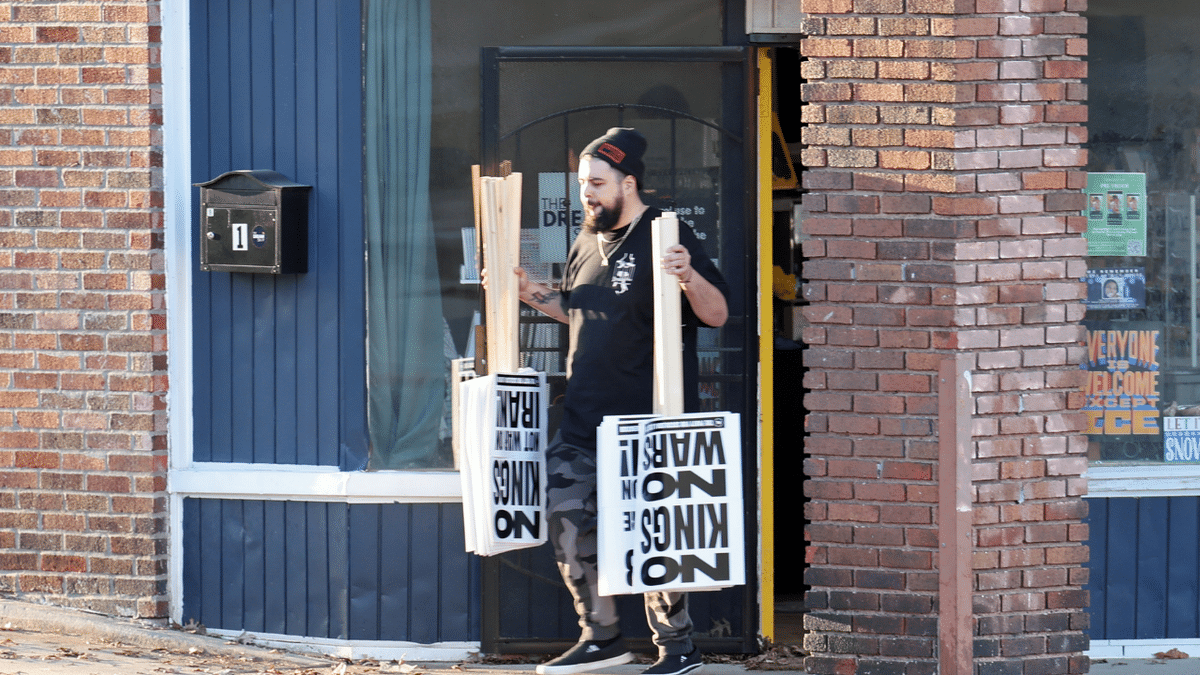 Man holding signs upside down