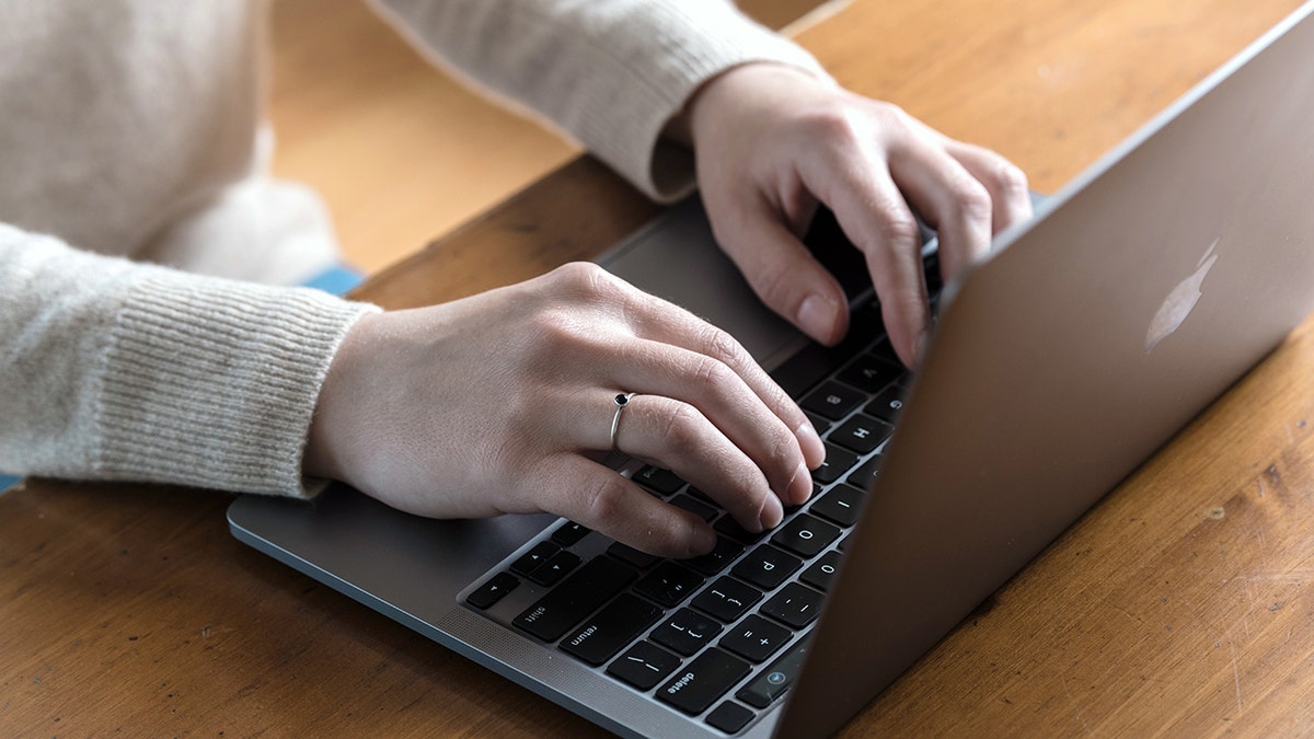 A person types on a computer.
