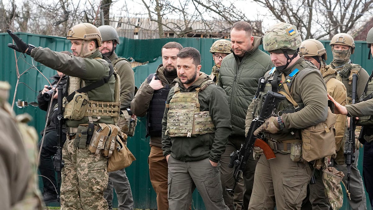 Ukrainian President Volodymyr Zelenskyy examining a battle site in Bucha near Kyiv