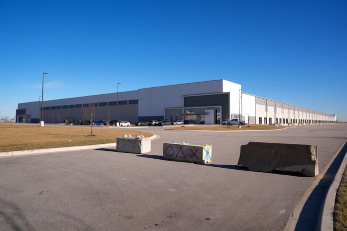 Barricades block a drive outside a warehouse as federal officials tour the facility to consider repurposing it as an ICE detention facility Thursday, Jan. 15, 2026, in Belton, Mo. (AP Photo/Charlie Riedel)