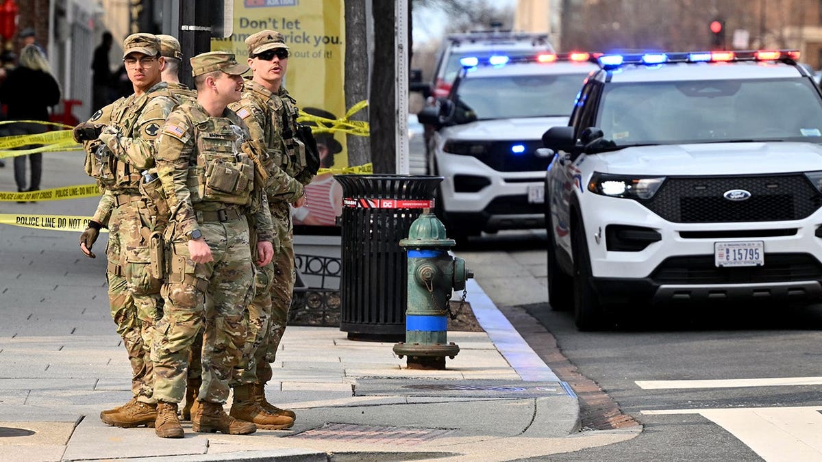 Washington DC national guard on patrol with police vehicles parked