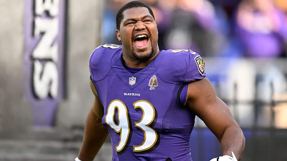 Calais Campbell wearing number 93 jersey stands on field at M&T Bank Stadium.