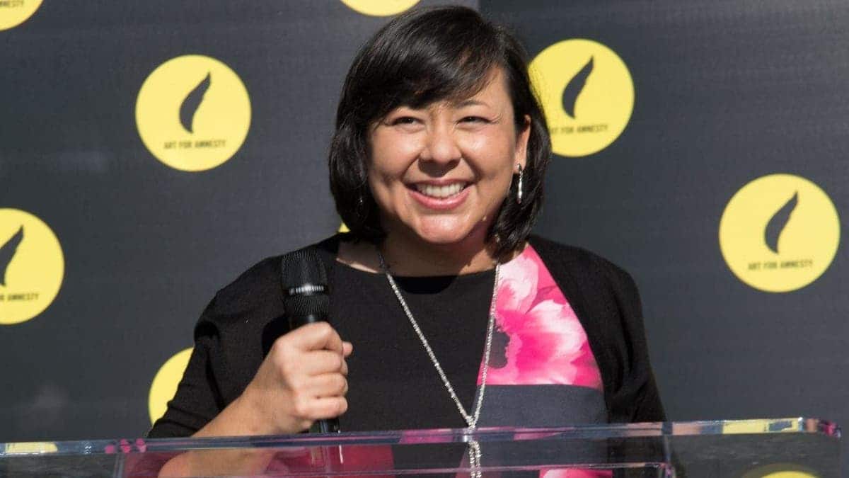 Margaret Huang standing and smiling at an event
