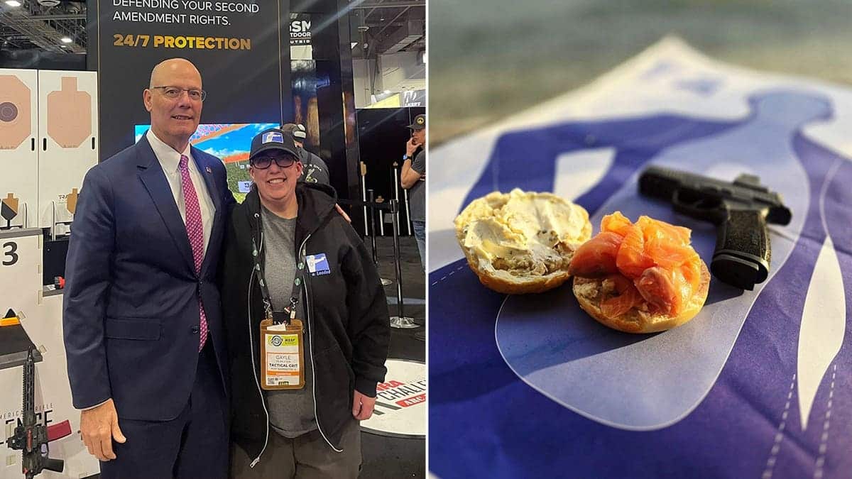Lox & Loaded co-founder Gayle Pearlstein poses with NRA CEO Doug Hamlin and an image of a bagel with lox next to a gun
