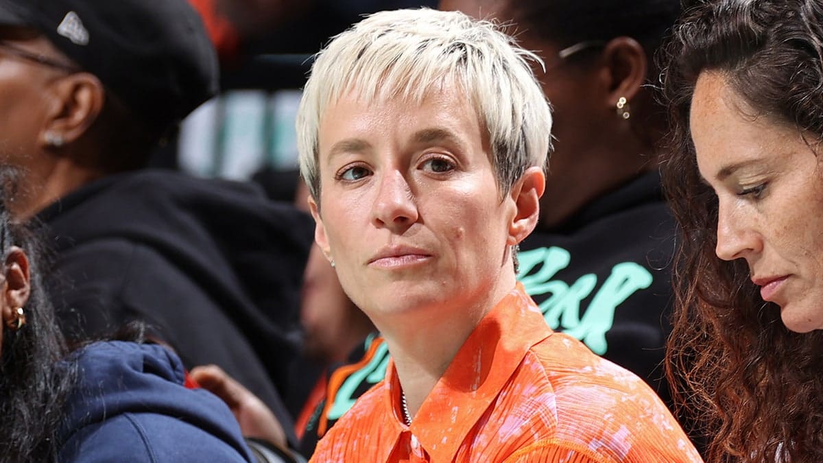 Megan Rapinoe sits courtside