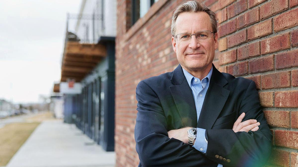 Former U.S. District Attorney Kurt Alme leans against a wall.