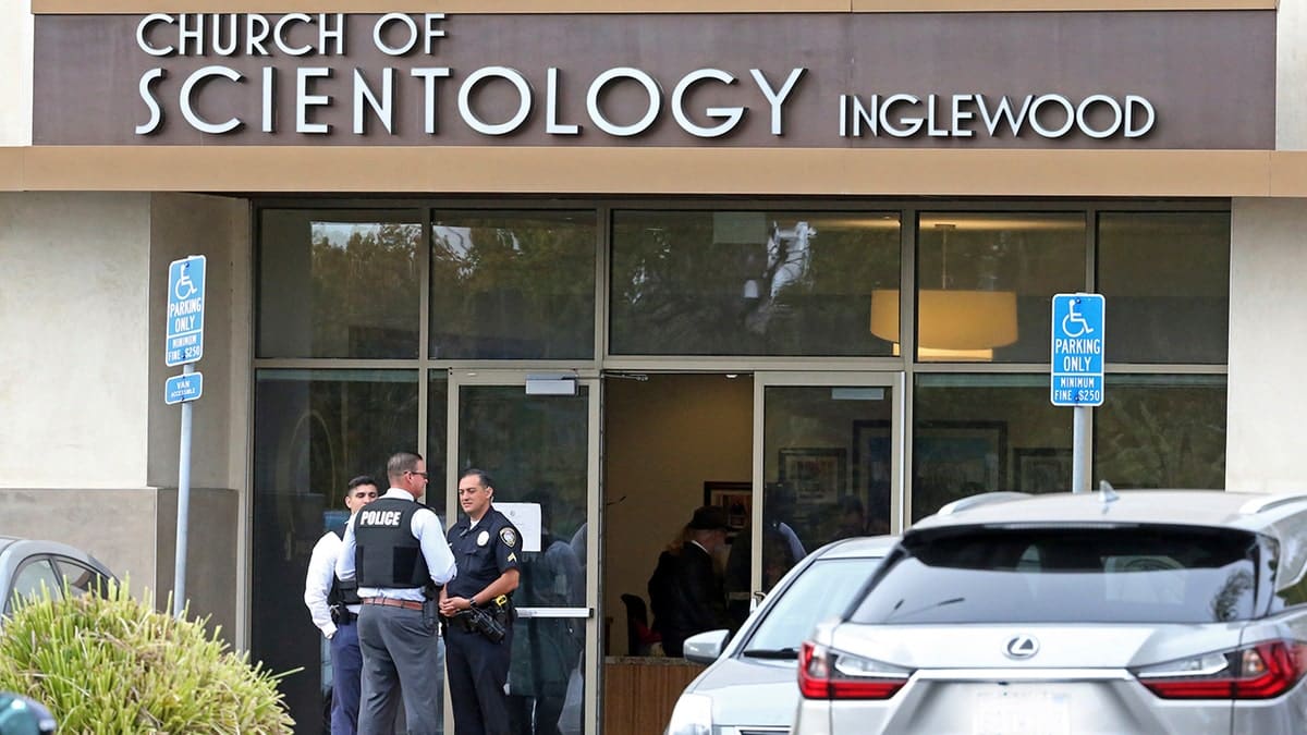 Police stand outside the Church of Scientology after a shooting involving two police officers and a suspect armed with a sword in Inglewood, Calif., Wednesday, March 27, 2019. The two police officers were shot and wounded while confronting the suspect who was also shot during the confrontation at the church later died at a local hospital.