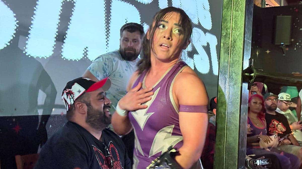 AMIRA holds her belt after a win