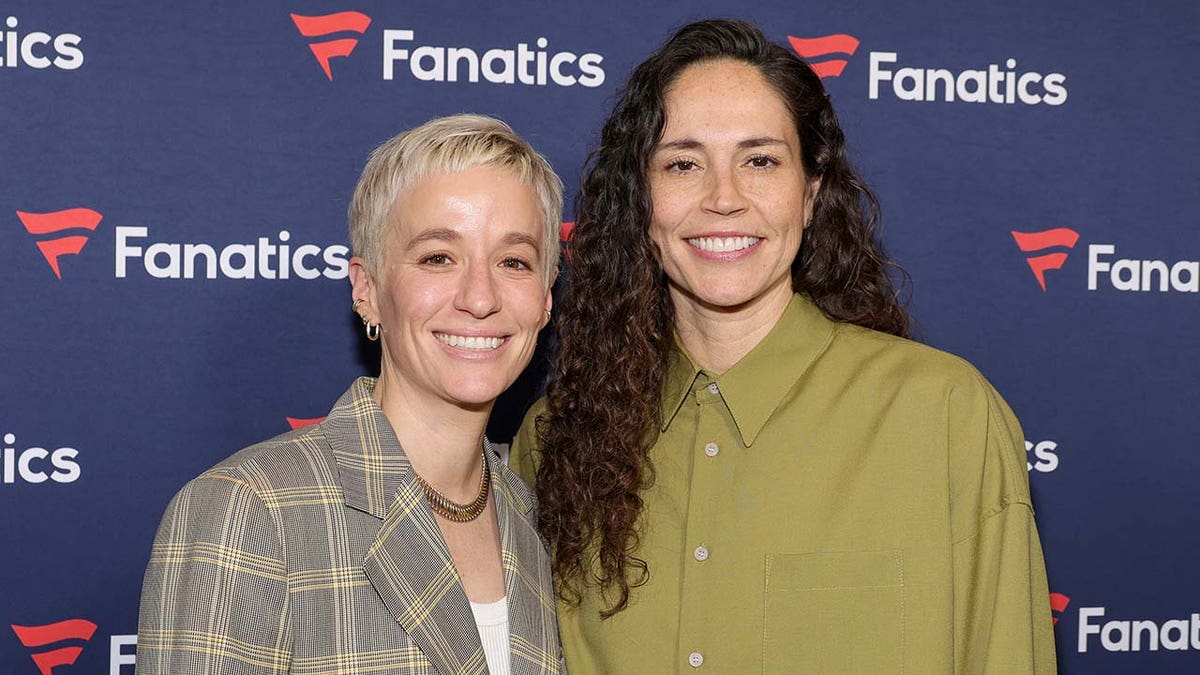 Megan Rapinoe and Sue Bird standing together at a nightclub event