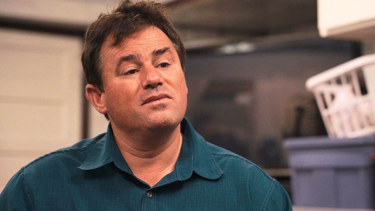 Samuel Bateman wearing a blue shirt in a scene from